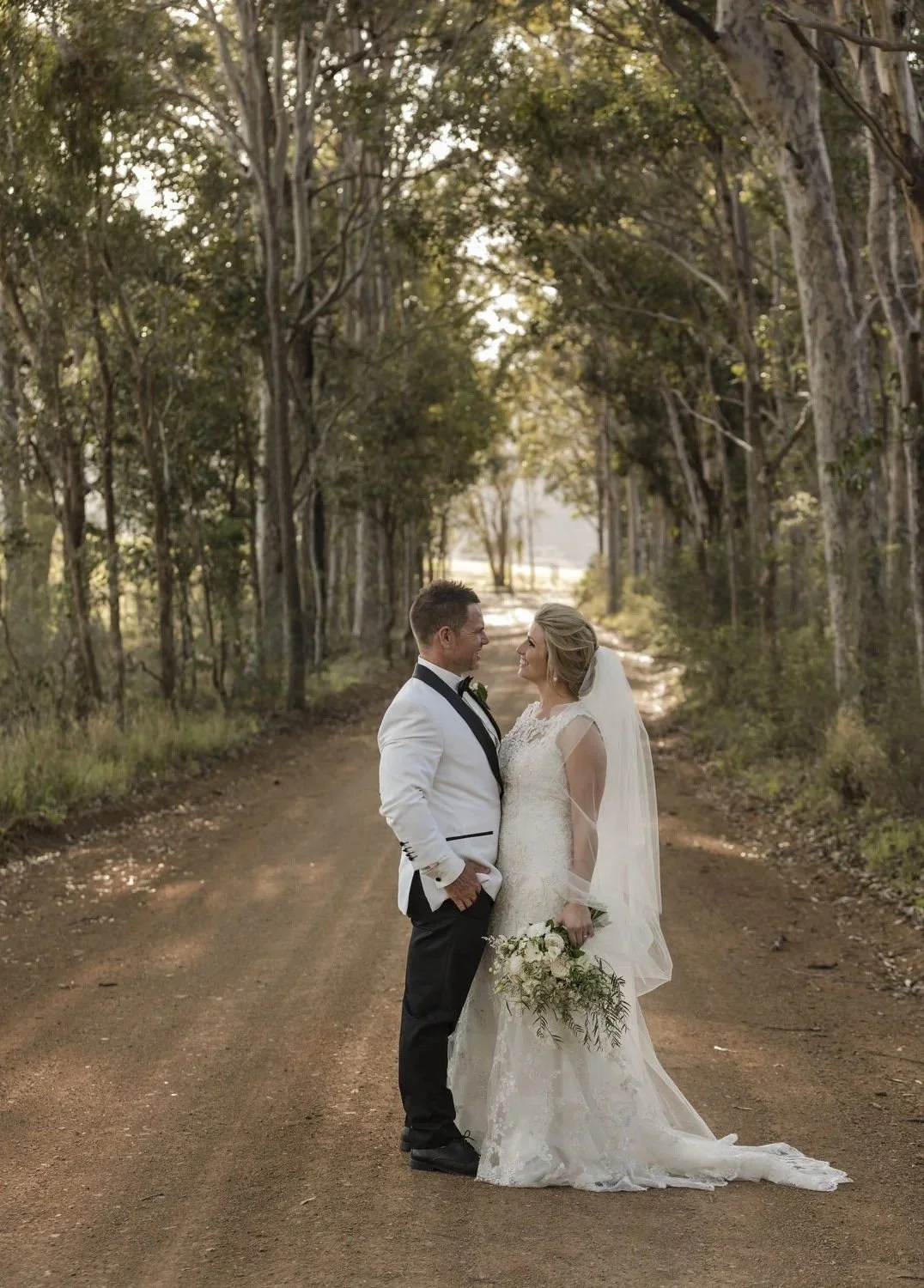 Couple on a tree-lined dirt track in the bushland surrounding Spicers Vineyards Estate, Pokolbin
