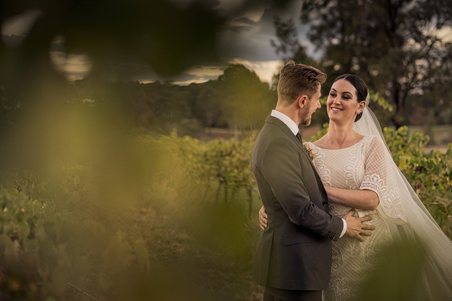 Bride and groom embracing in a garden setting