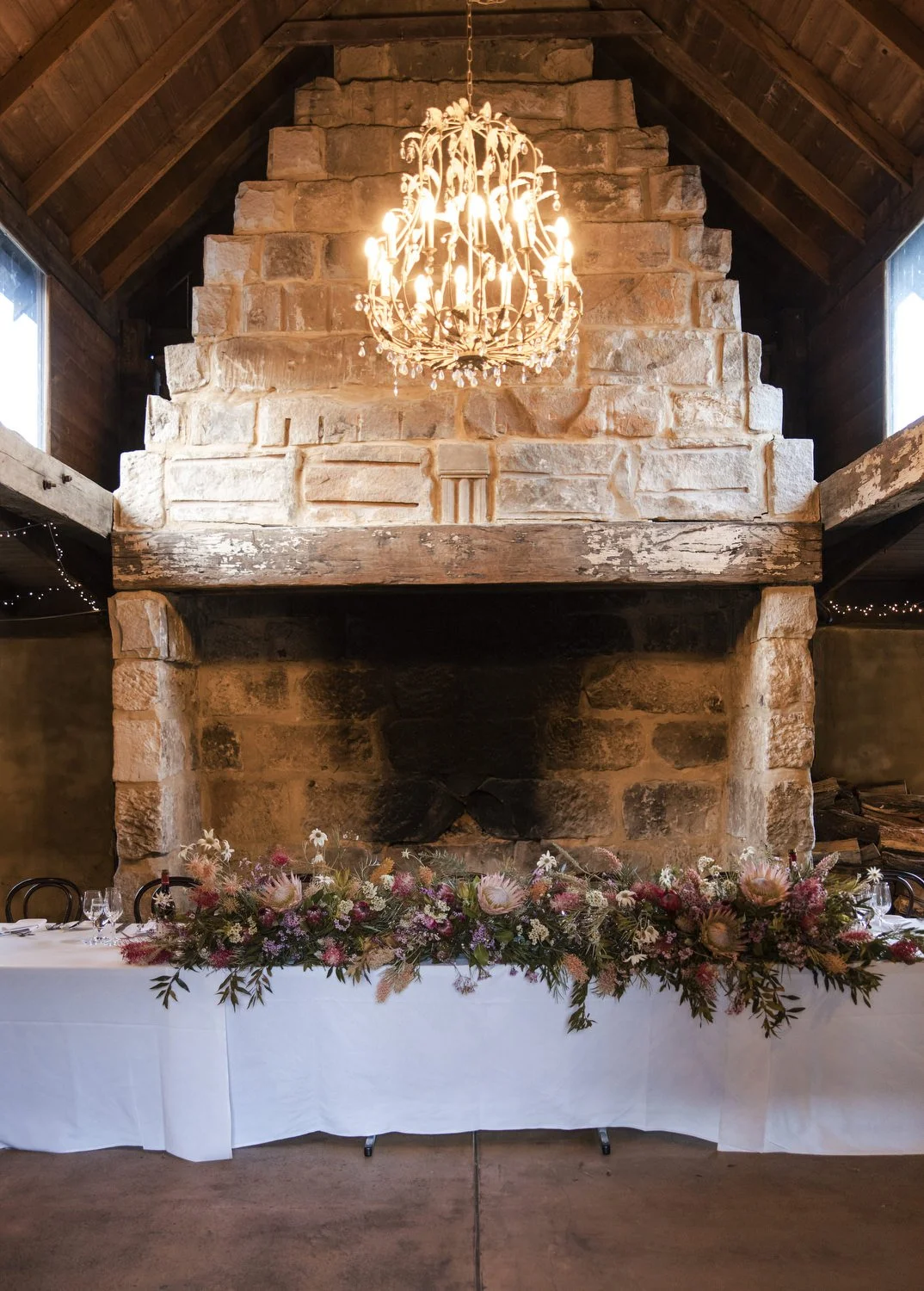 Peppers Creek Barrel Room  fireplace with flowers setup