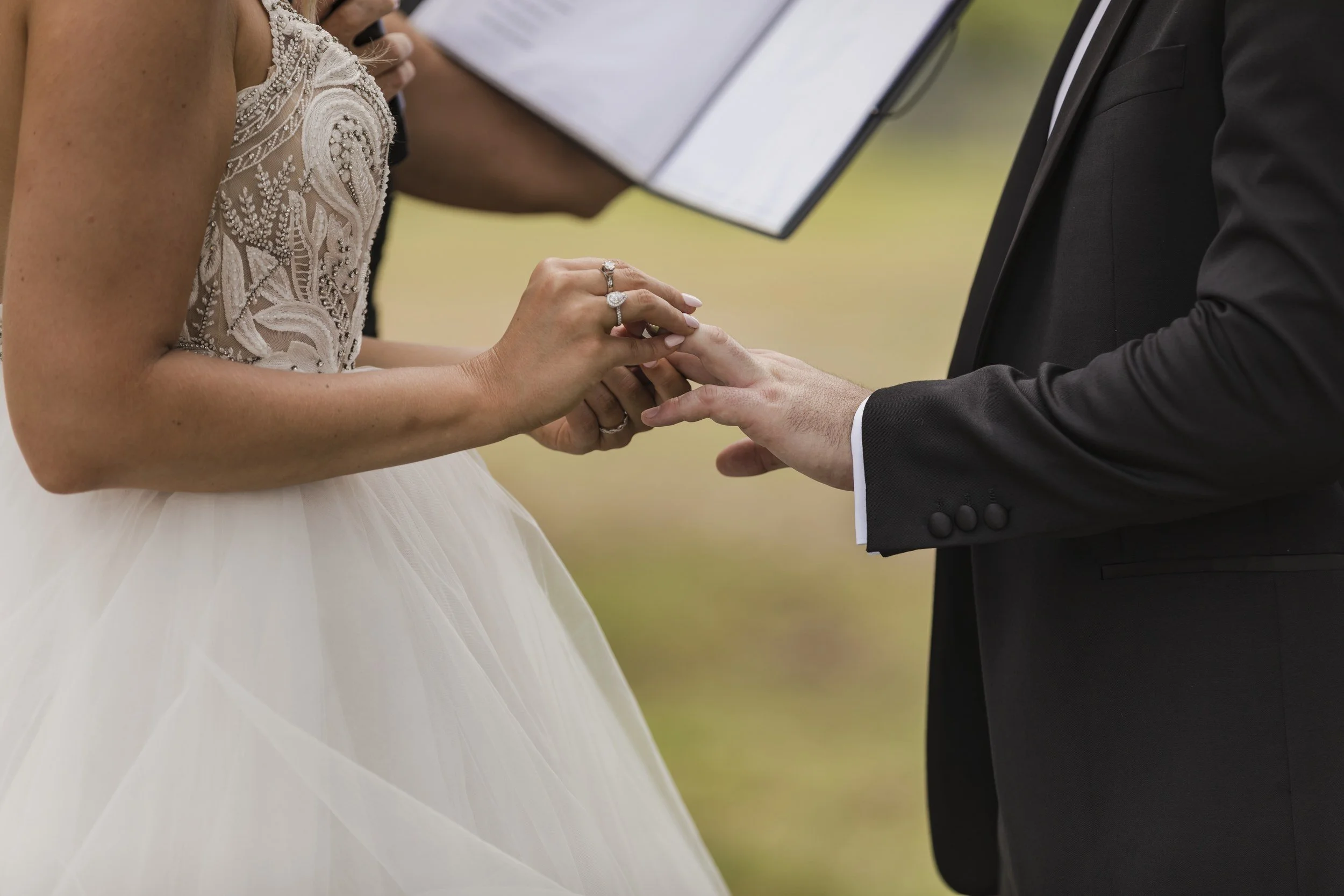 Close-up of a couple's hands during the ring exchange at their ceremony