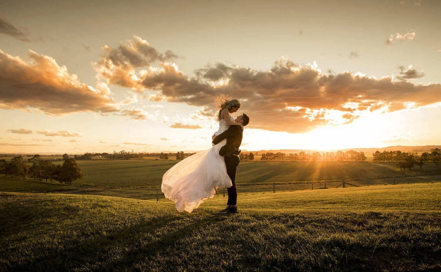 Joyful Hunter Valley newlyweds dancing at sunset