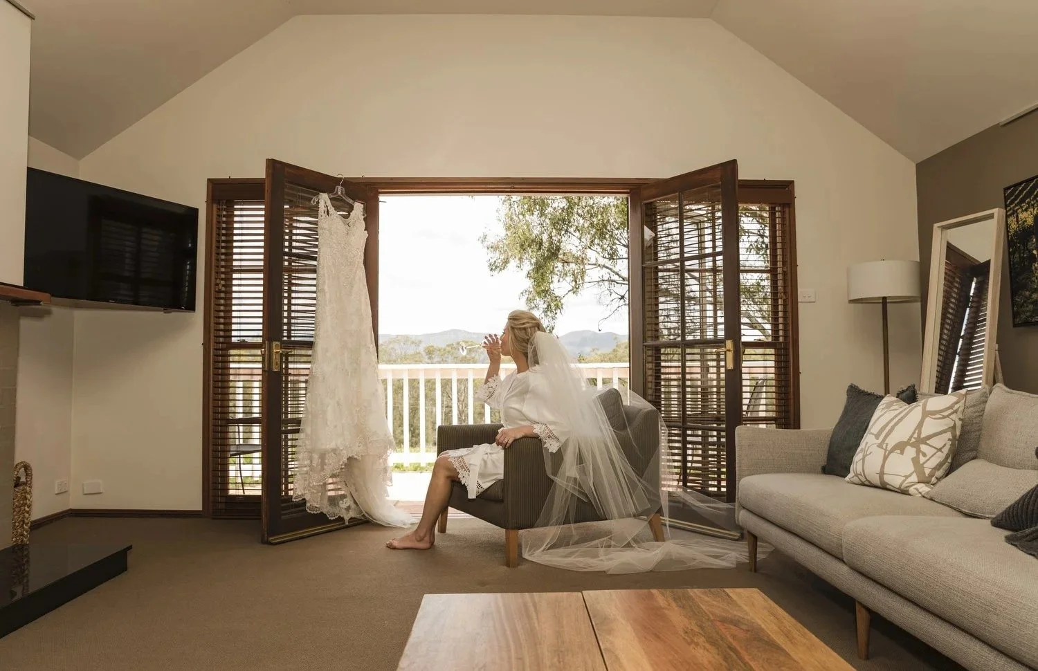 Bride getting ready in a guest suite with doors open to the view, Spicers Vineyards Estate, Pokolbin