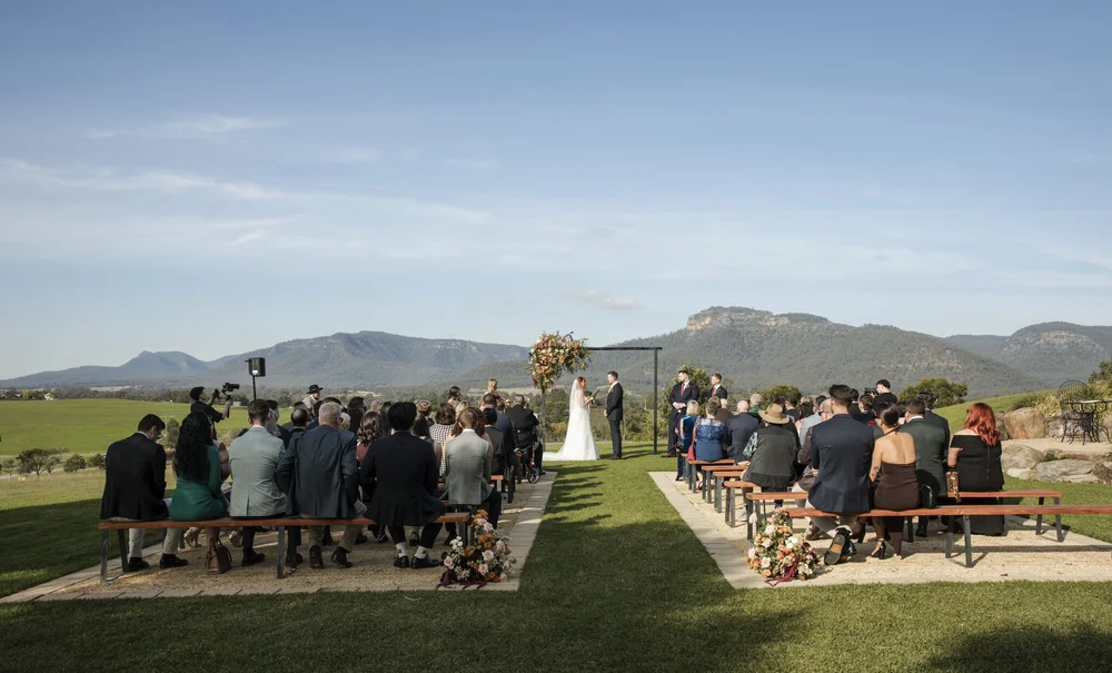 Wide view of a lawn ceremony with guests and the range on the horizon, Adams Peak Country Estate, Broke