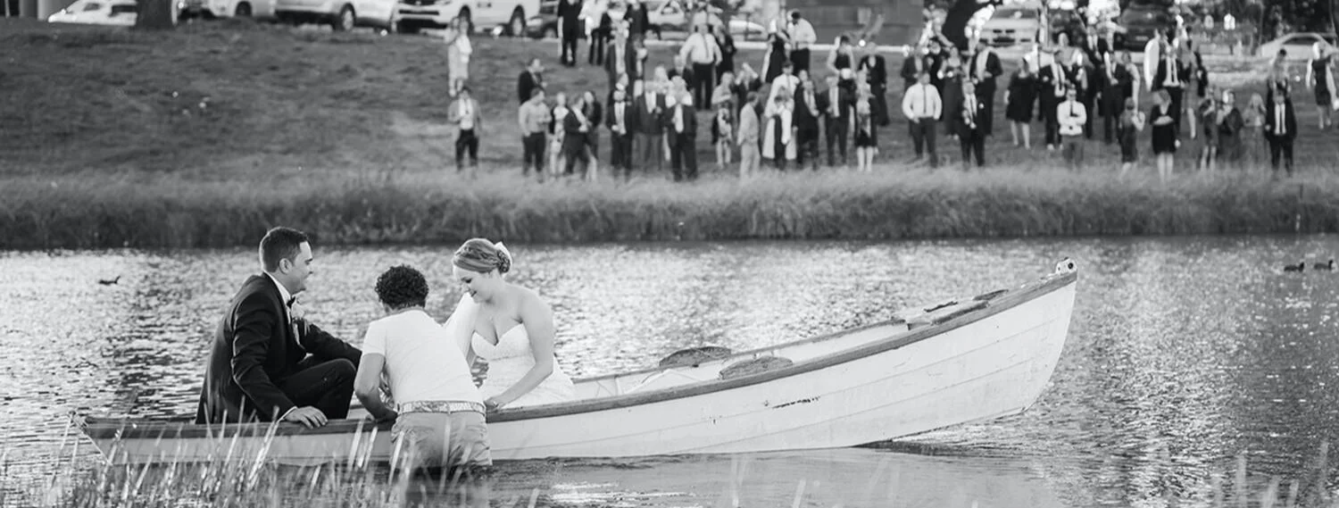 Bride and groom sharing an unhurried moment in a rowboat