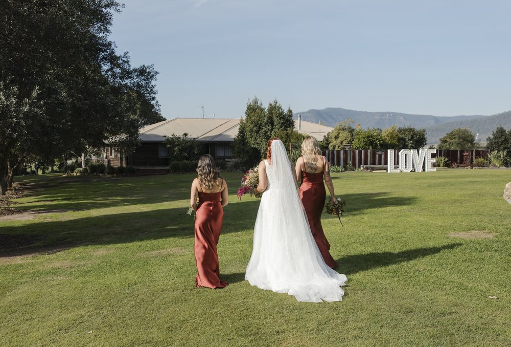 Bride walking across the lawn with her bridesmaids towards the ceremony, Adams Peak Country Estate, Broke