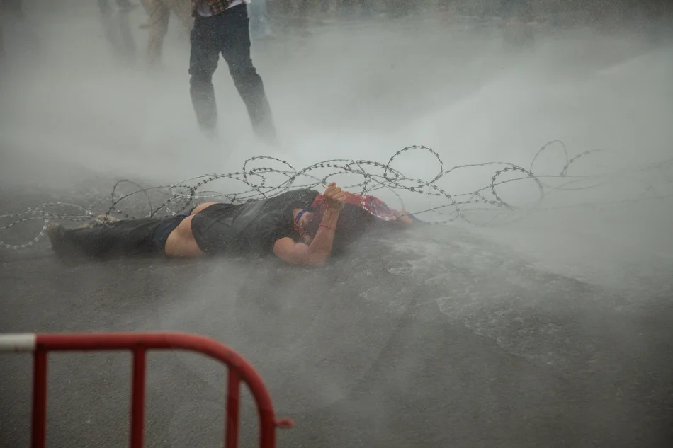 15/09/2013 - Phnom Penh. A CNRP supporter got trapped in the barb wire and injured by a water cannon. © Thomas Cristofoletti / Ruom 2013