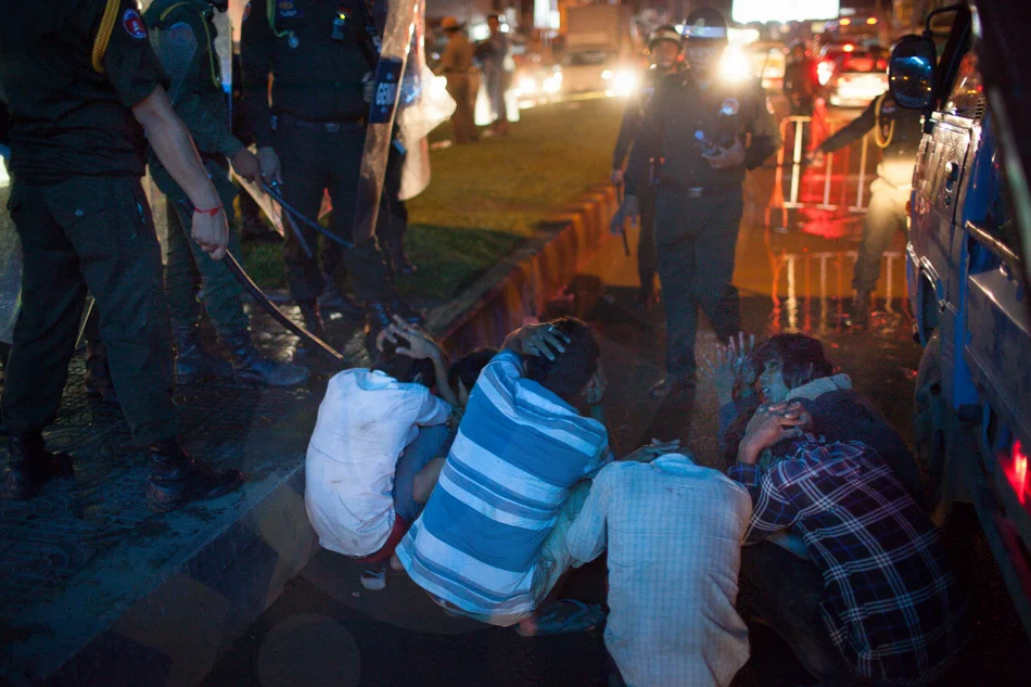 People are detained by police after clashes erupt in Phnom Penh after commuters were barred from returning home. Angry protestors confronted riot police who responded with tear gas and live rounds. The leading opposition party, the CNRP, are holding three day mass demonstrations to contest the Cambodian general election results. Sept. 15, 2013. © Thomas Cristofoletti / Ruom