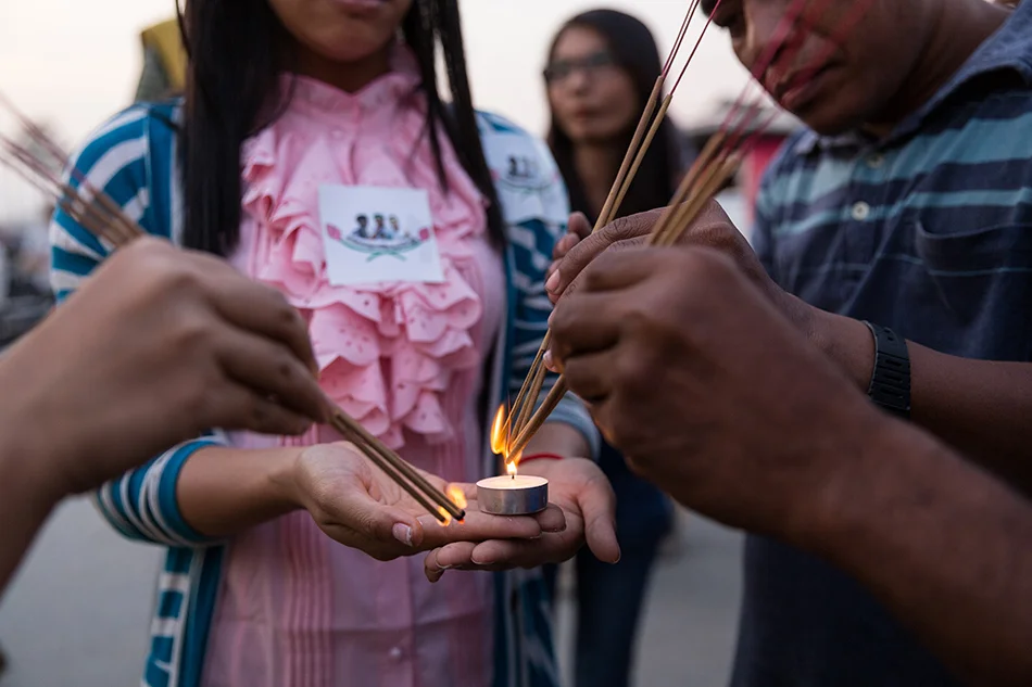 February 01, 2014 - Phnom Penh, Cambodia. People light incense during a ceremony held by activists and monks from the Independent Monk Network for Social Justice (IMNSJ) in commemoration of the victims of garment clashes that took place in January 03, 2014. The IMNSJ and activists also called for the release of 23 detainees, arrested during the clashes and still held in pre-trial detention. © Nicolas Axelrod / Ruom