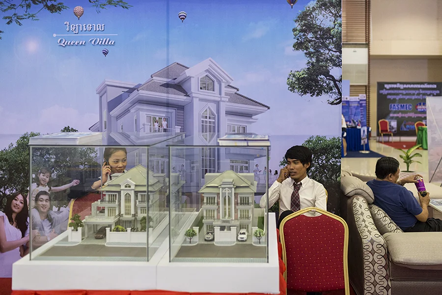 March 30, 2014 - Phnom Penh, Cambodia. Sales people talk on the phone during an Expo about Cambodia on Koh Pich. © Nicolas Axelrod / Ruom