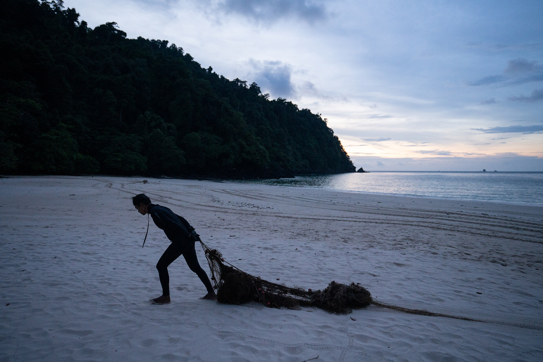  Nov. 03, 2019 - Mergui Archipelago, Myanmar. Anuar Abdullah, founder of Ocean Quest pulls a ghost net onto the beach. © Nicolas Axelrod / Ruom 