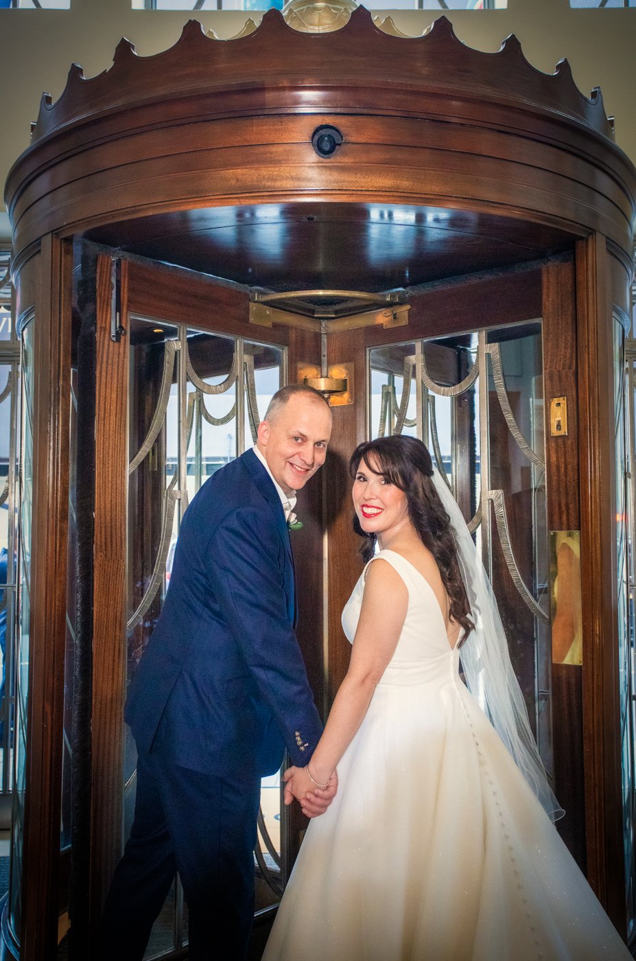 wedding-photograph-claridges-revolving-door-couple-portrait.jpg