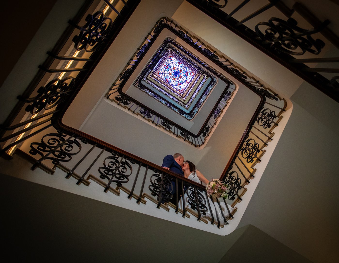 wedding-photograph-claridges-spiral-staircase-skylight.jpg