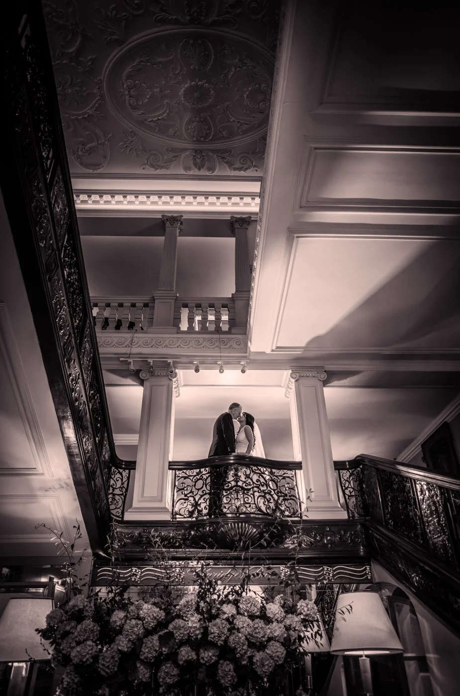 wedding-photograph-claridges-balcony-kiss-black-white.jpg