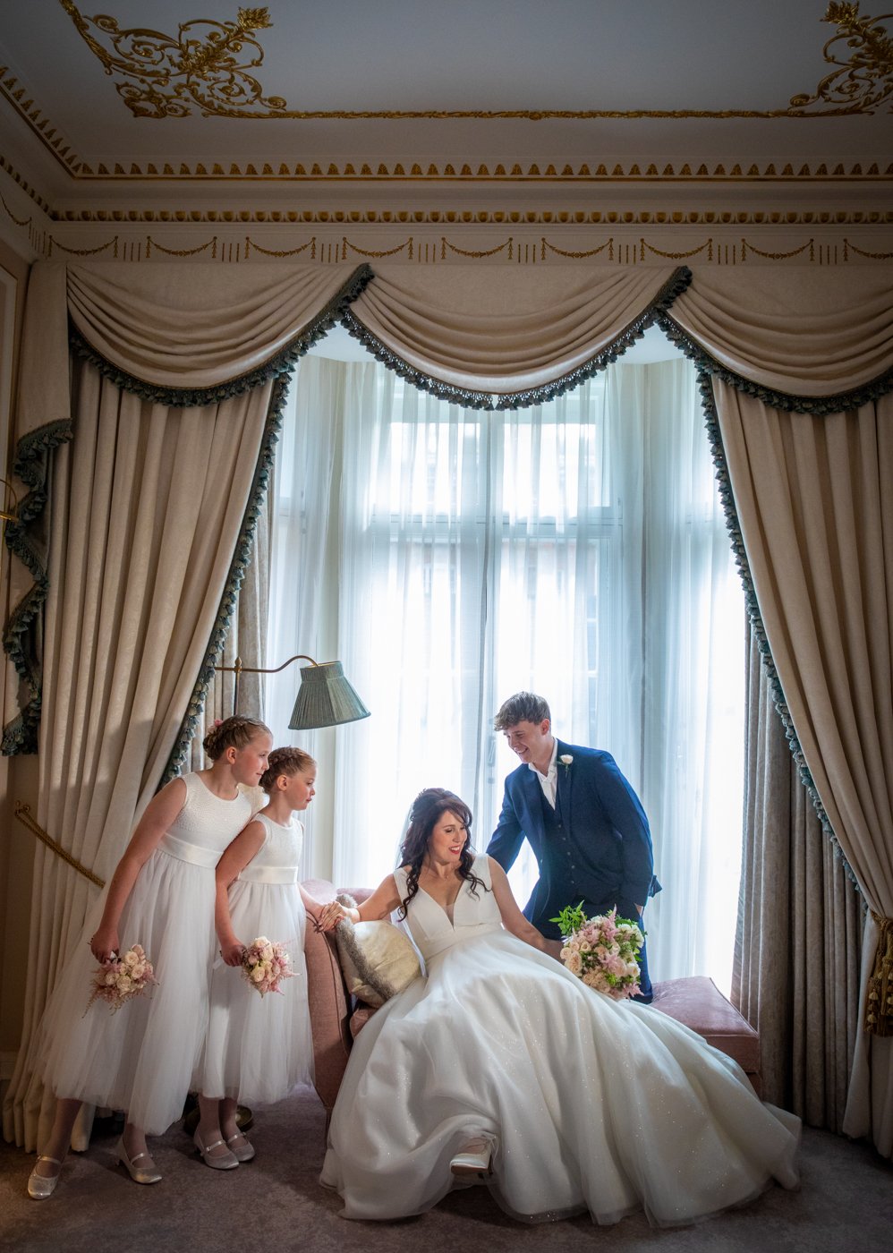 wedding-photograph-claridges-bride-bridesmaids-window.jpg