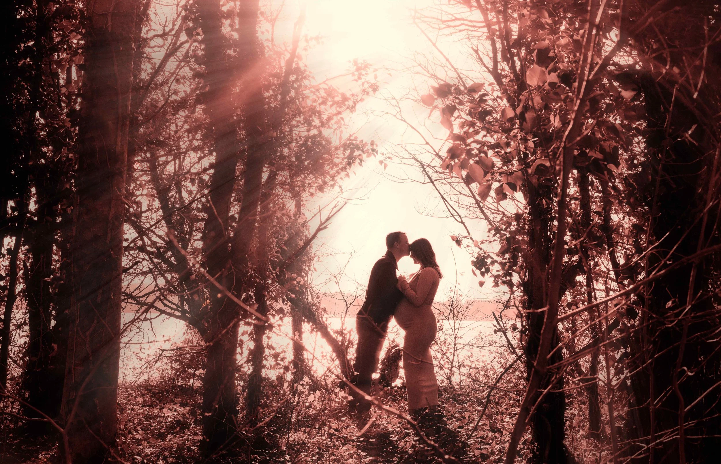 romantic-maternity-couple-silhouette-woodland-red-tones.jpg