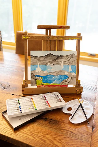 Watercolor Painting on Easel with Paints and Brushes.jpg