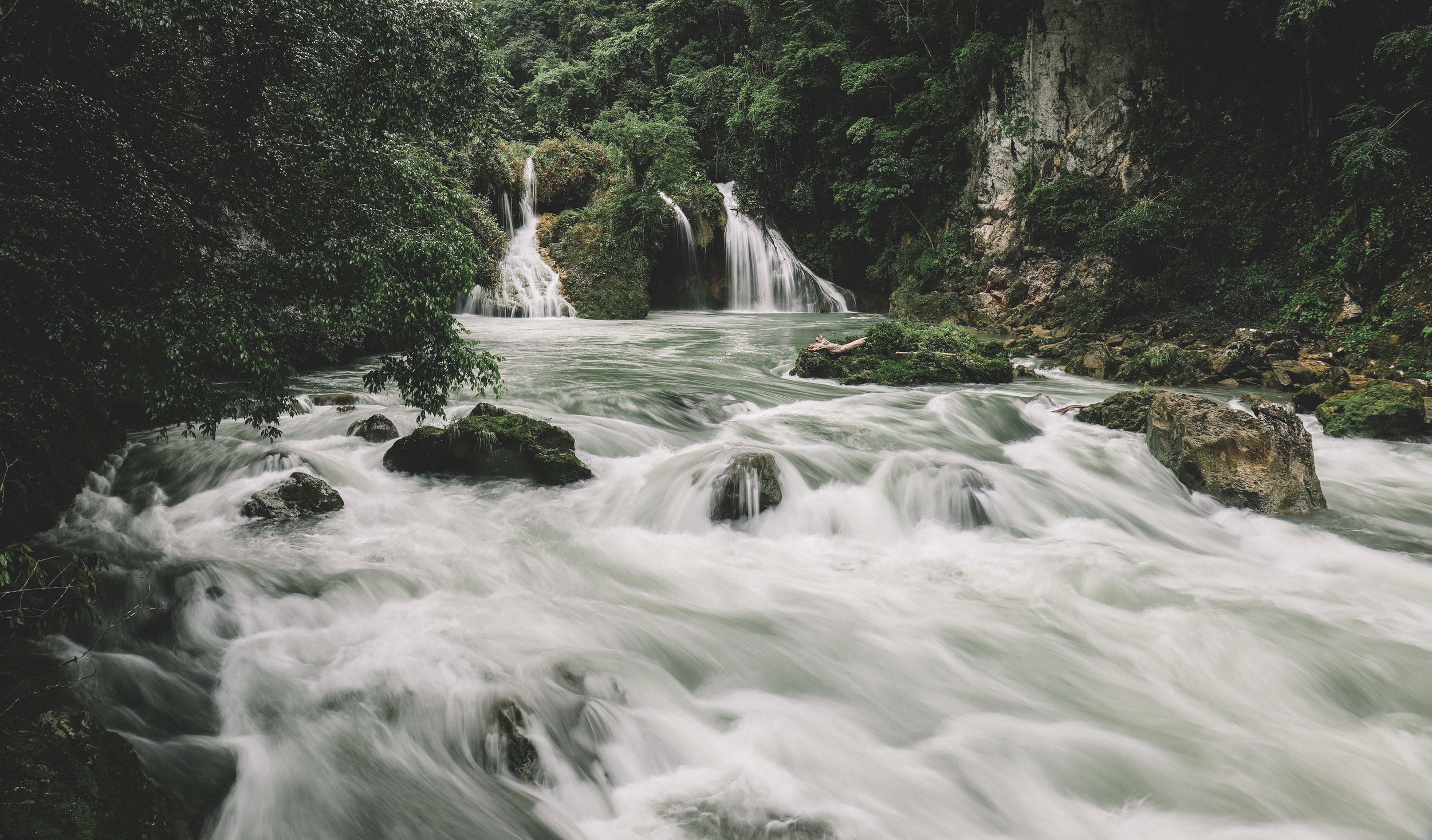 The Cahabón River emerging from under the naturally formed limestone bridge.