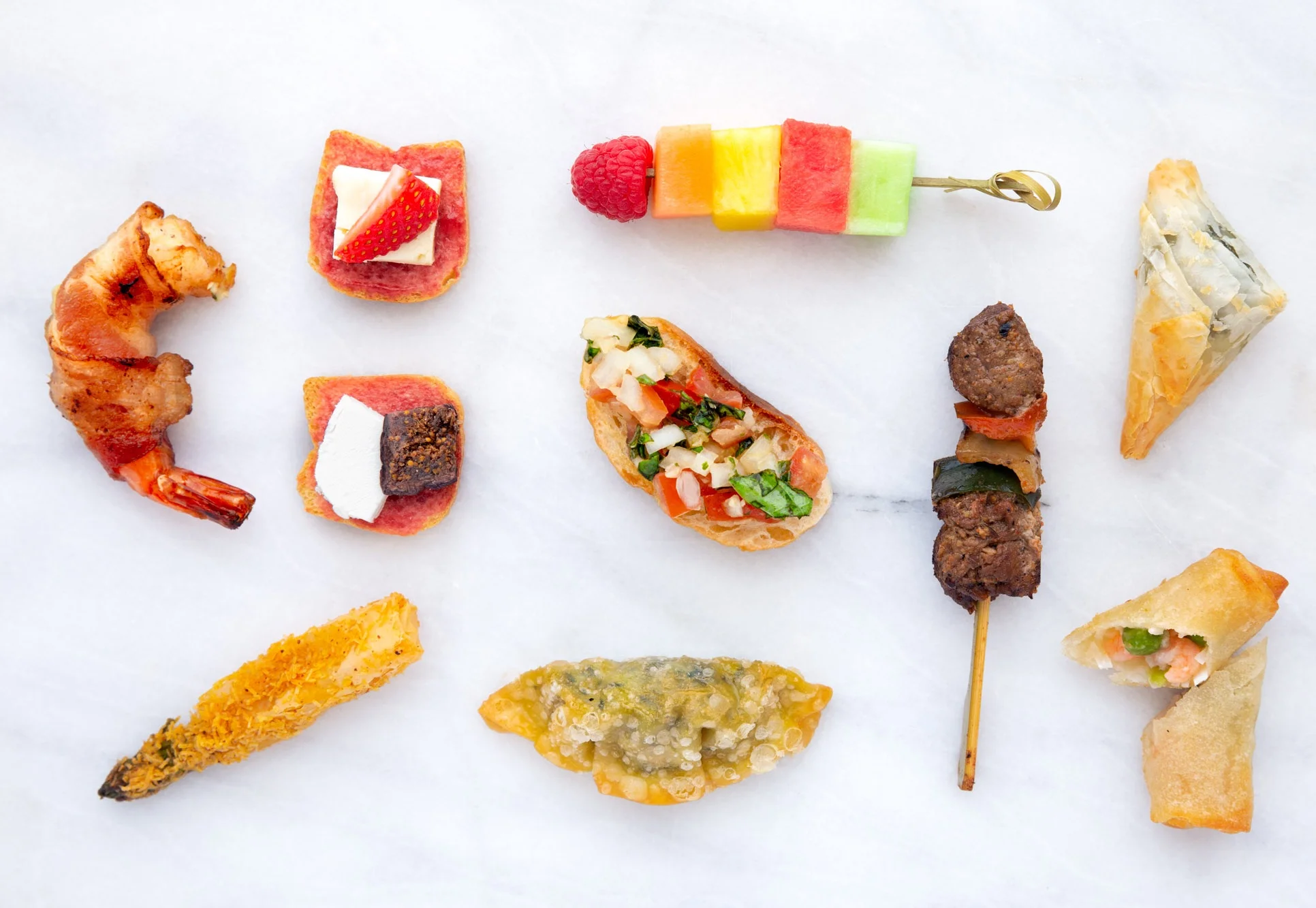 Top Row, L-R: Bacon Wrapped Shrimp, Brie & Strawberries on Toast, Seasonal fruit Skewer, Spanakopita; middle Row, L-R: Fig & Goat Cheese on Toast, Bruschetta, Chipotle Churrasco Steak Skewer; Bottom Row, L-R: Asparagus Asiago Roll, Kale Pot Sticker, Thai Shrimp & coconut Spring Roll; PC, Taming of the Spoon