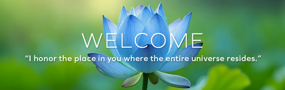 Side view of a blue lotus flower with a blurred green and blue background.