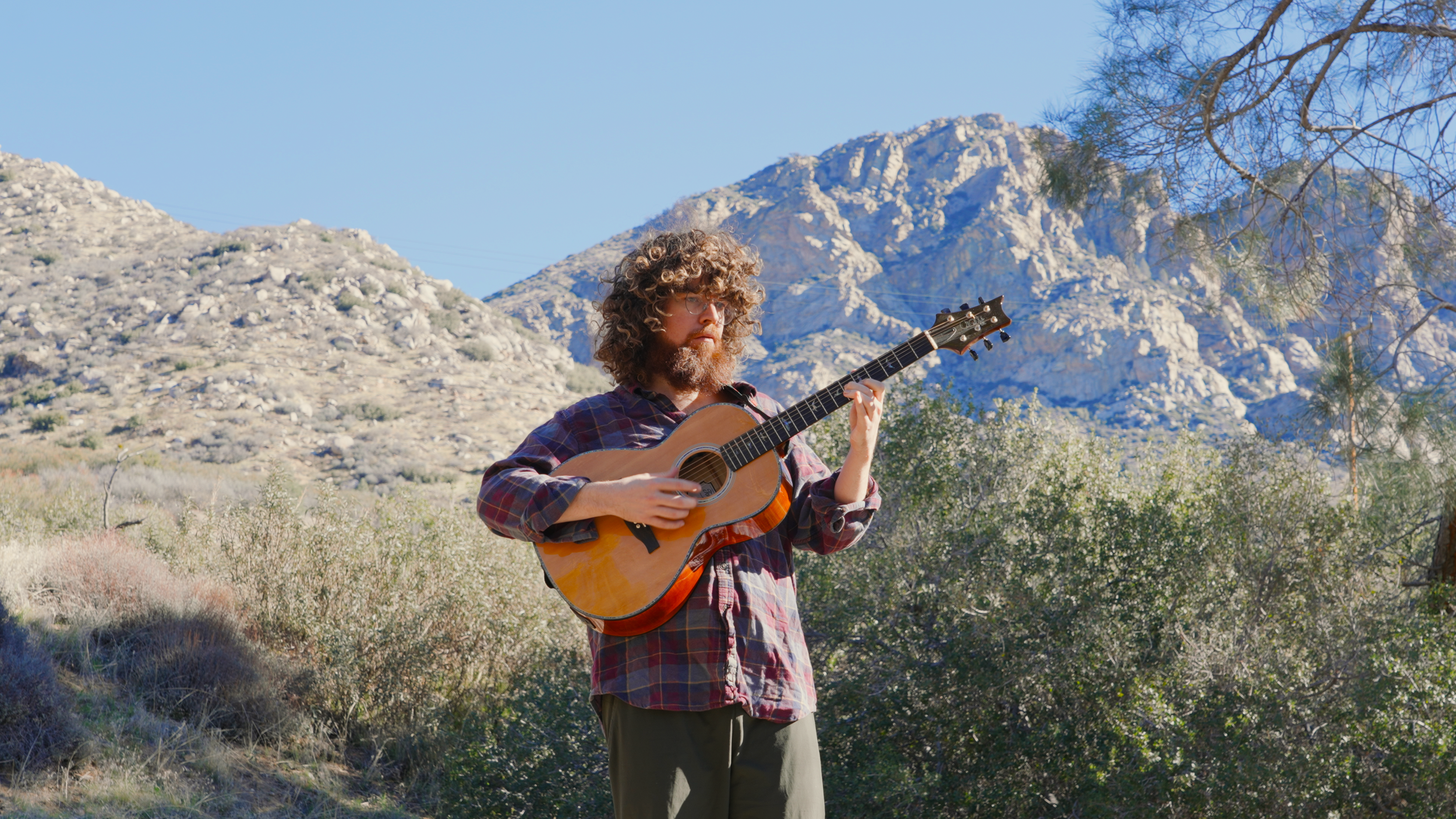 _JW PLAYING GUITAR IN nature.00_00_11_04.Still006 copy.png