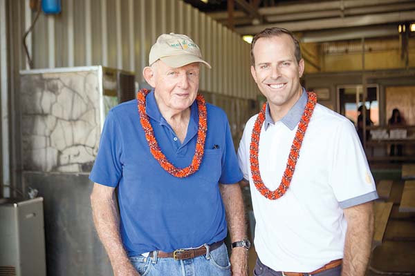 Ulupalakua Ranch’s Pardee Erdman, one of the former owner investors of Maui Gold Pineapple Co., stands with Joe LeVecke, president of Maui Gold Pineapple Co. and Hali‘imaile Distilling Co.