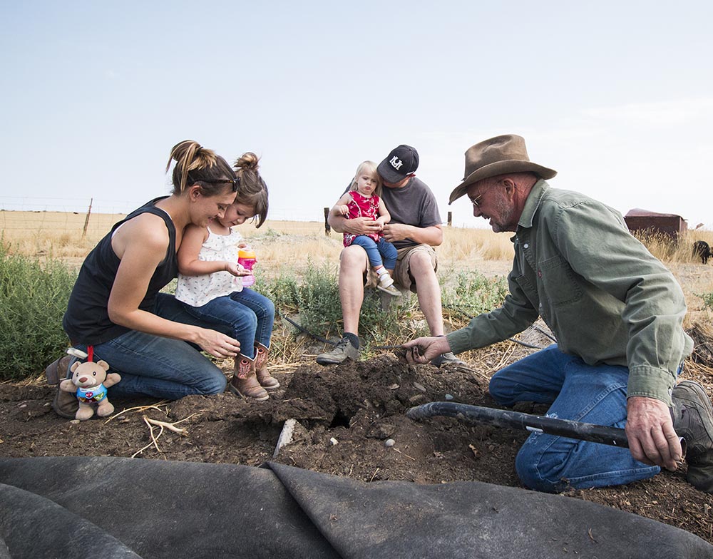 Steve and his family look for worms in the regenerated soil.