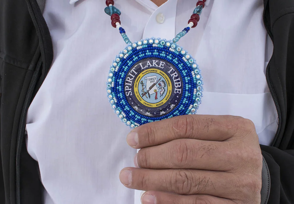 Doug Yankton holds an emblem that a Spirit Lake Tribal member gave him.