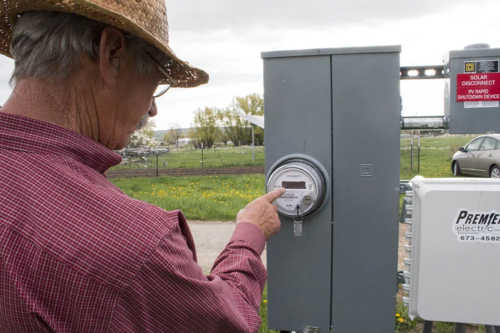 Tom checks the levels of his solar panels.