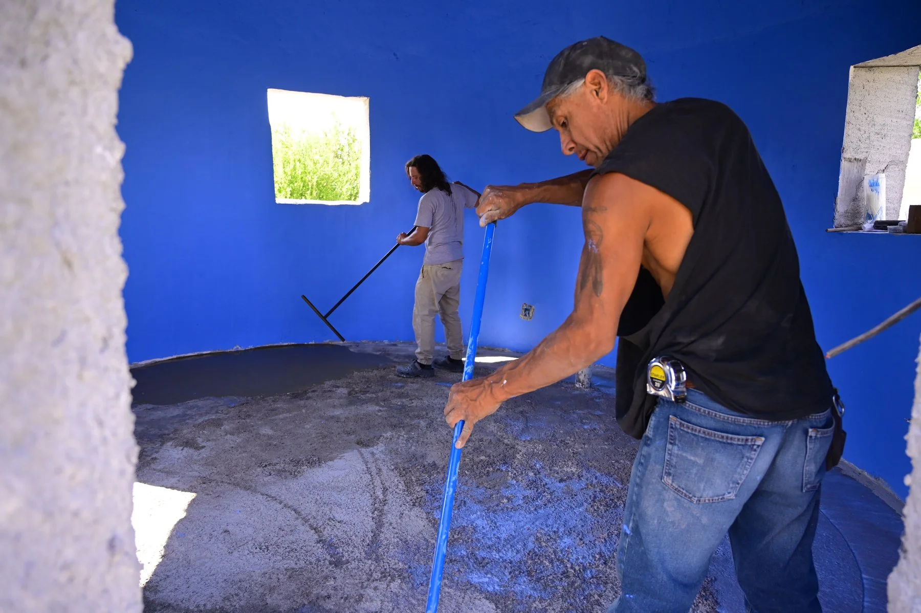  Jason Mackie and Leo Bear apply a self leveling flooring in a model home.  