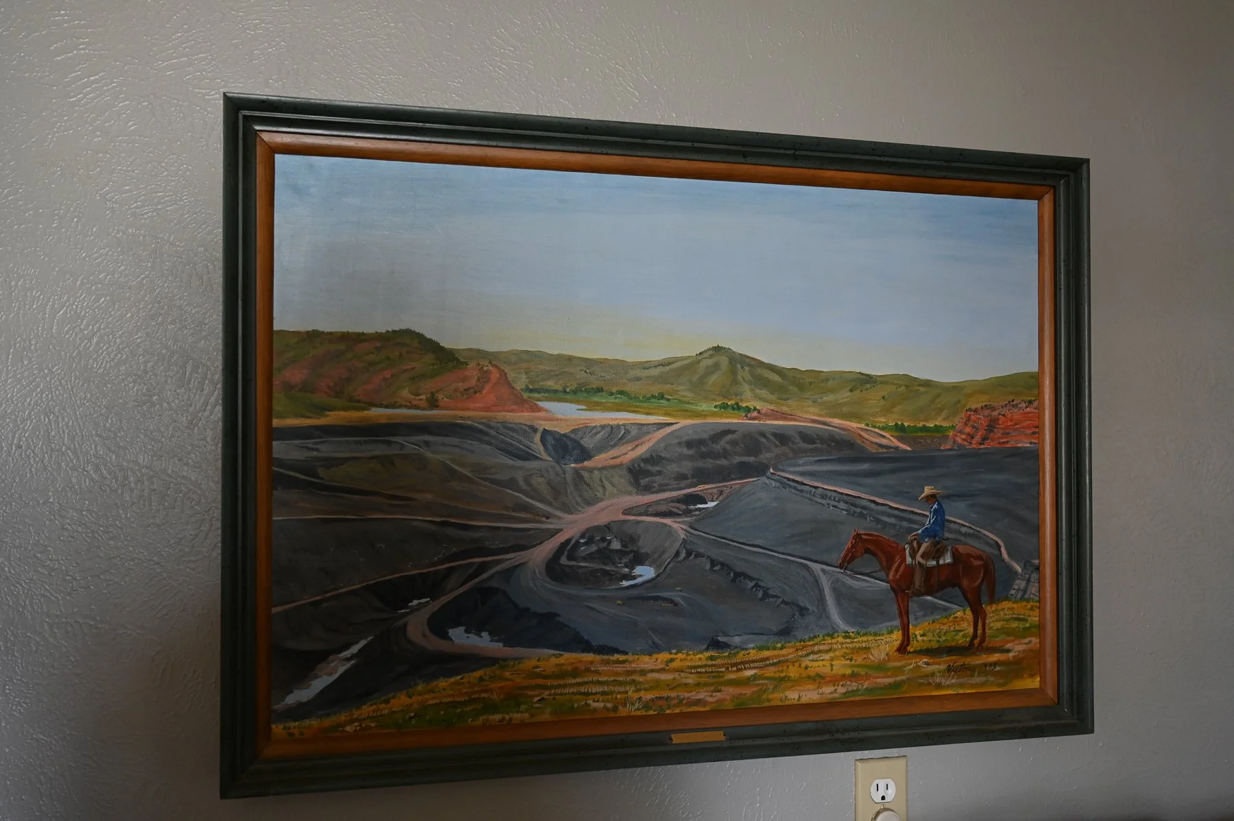  A painting in the Powder River office depicts a rancher looking over the coal mine.  