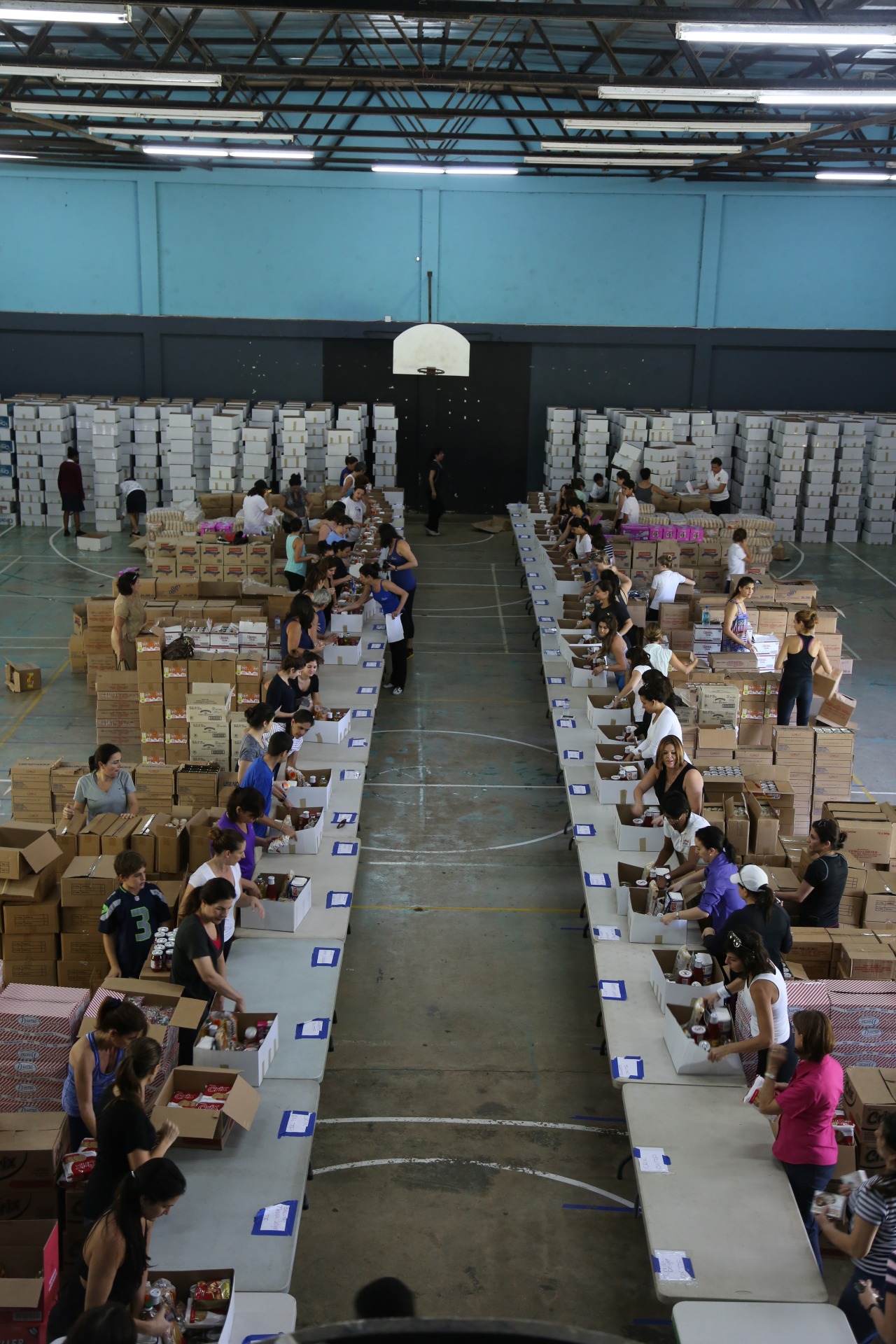 Annually, members of the Syrian Lebanese Women’s Association pack 1,500 food hampers at St. Anthony’s College Auditorium in Westmoorings. The boxes are distributed to organisations and parishes which then share them out to underprivileged people in all corners of T&T. 9 December 2014. | The Guardian newspaper, Trinidad and Tobago