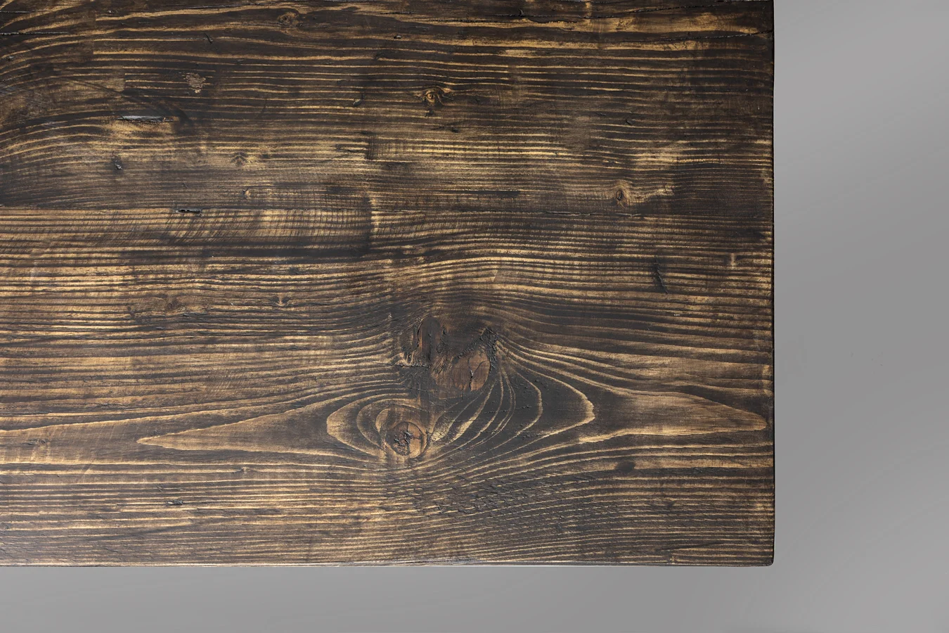 Dark stained reclaimed wood surface