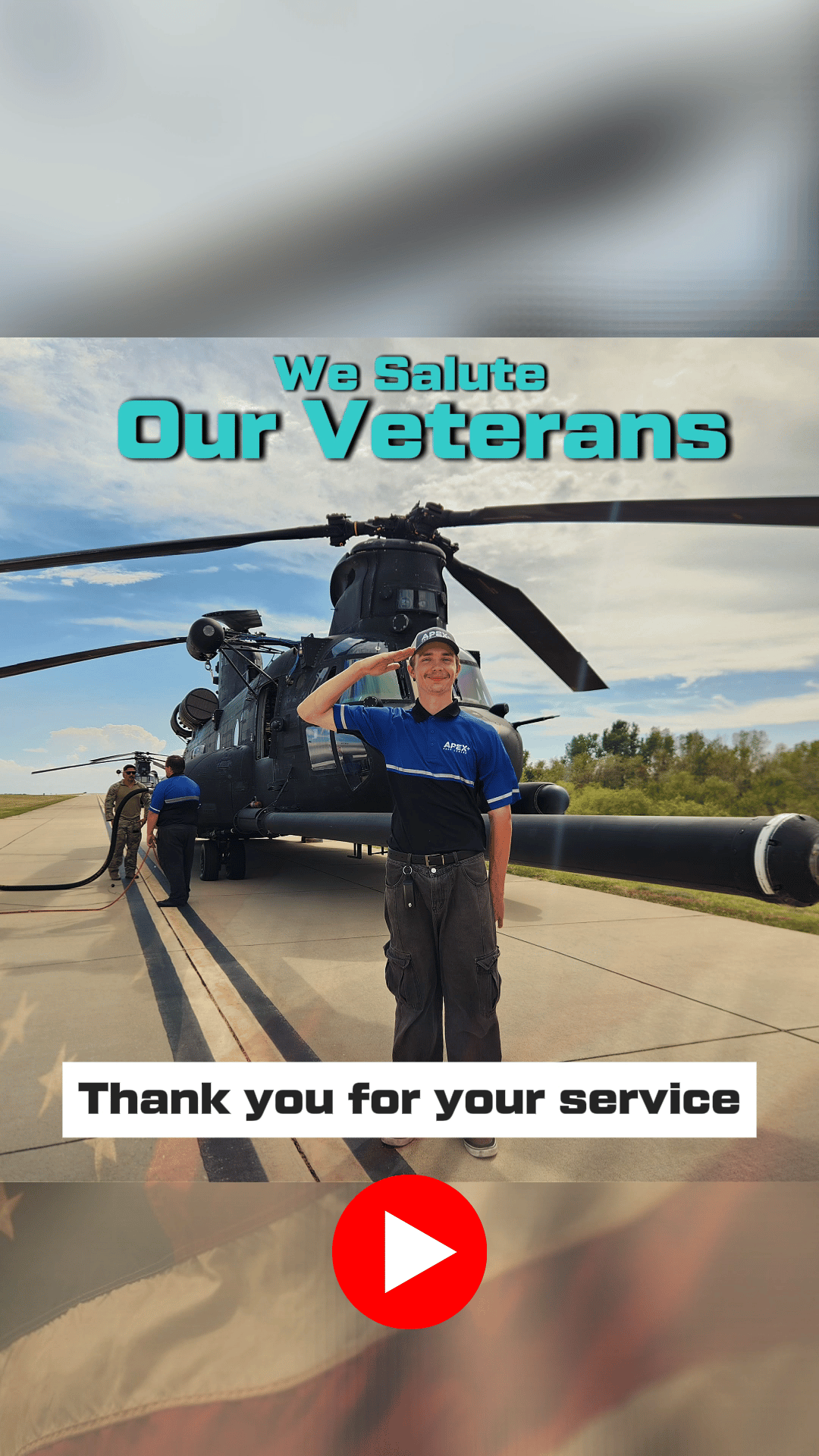 Apex Line Tech saluting while standing in front of a large military chopper