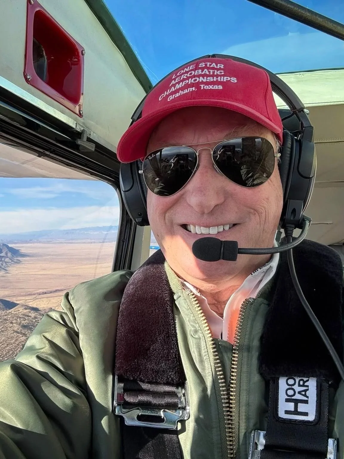 John Wise smiling as he's flying his aircraft