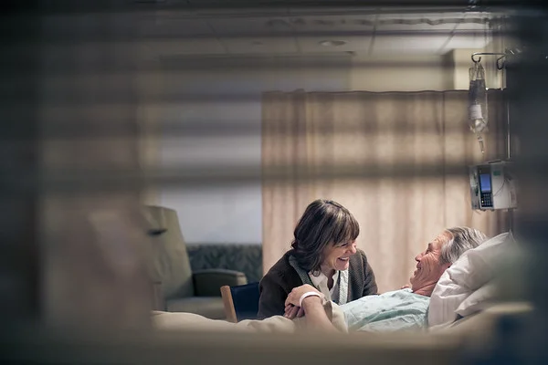 Couple-Laughing-Together-in-Husbands-Hospital-Room-M.jpg