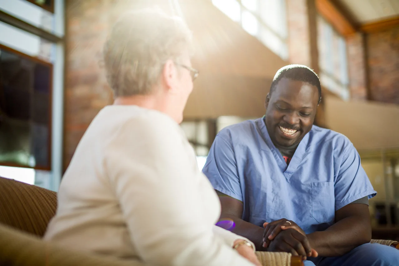 Male-Nurse-Laughing-With-Patient-in-Lobby-X2.jpg
