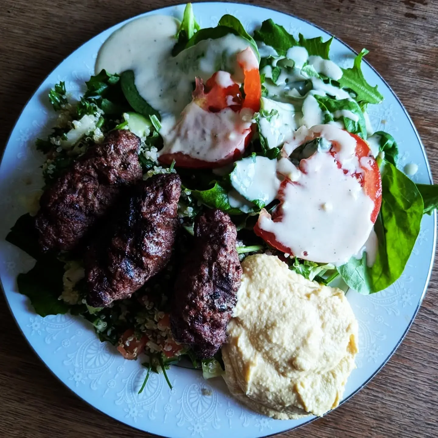 Beef Kofta with Quinoa Tabouli Salad, Greens, Tahini Dressing and Hummus. We enjoyed supper out on the back deck tonight. It was beautiful. #cedarknollgrassfedbeef #cedarknollfinch