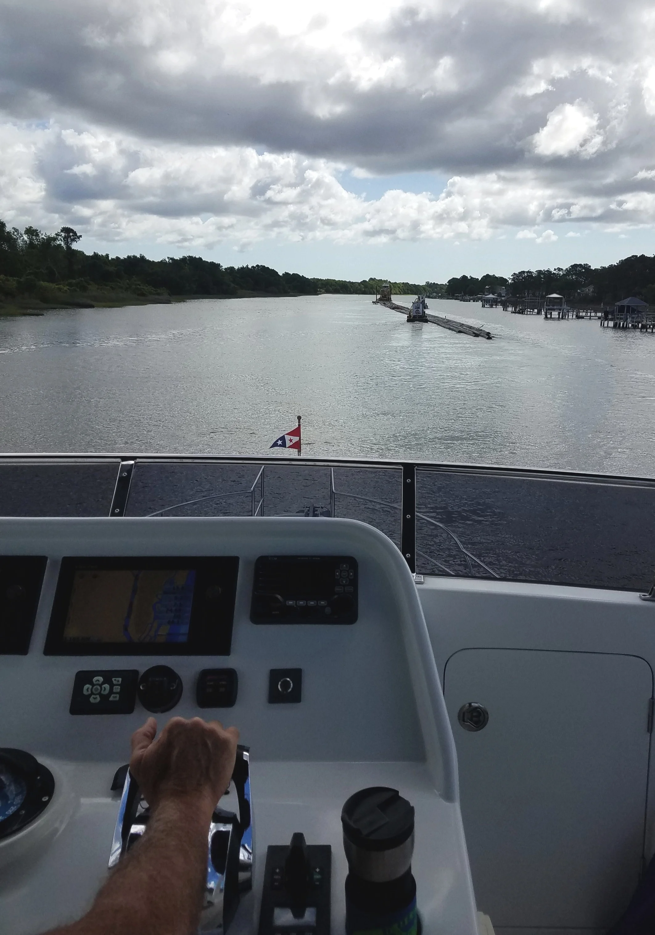 All sorts of traffic on the ICW. This is a barge hauling pipes pushed by a tug and two other pusher/puller tugs. Quite the hazard to pass.