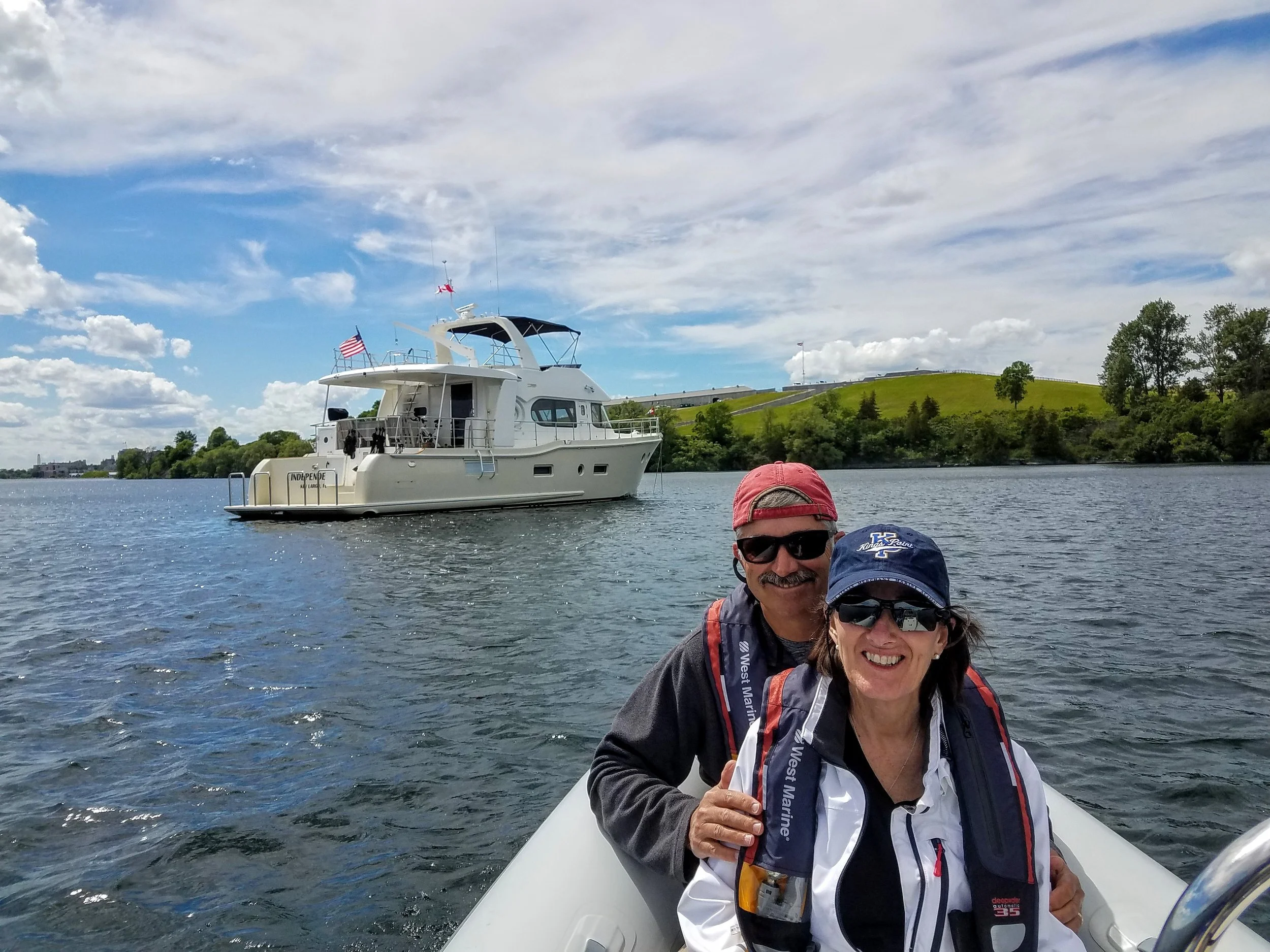 Anchored at Kingston, ON. Maggie and Owen on the tender heading to the city.