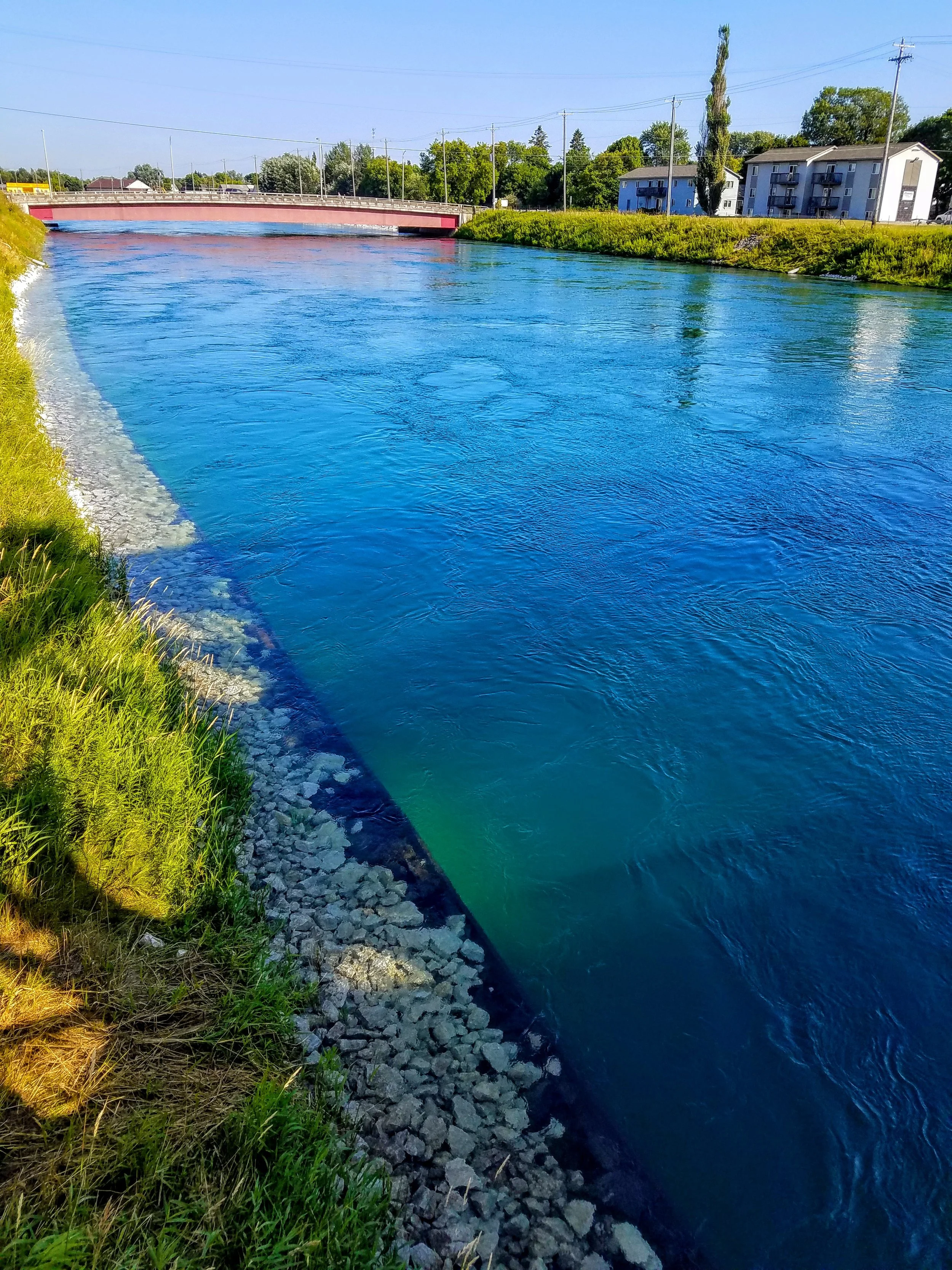 This crystal-clear blue water is moving toward the hydro electric power plant at about 8 knots or more