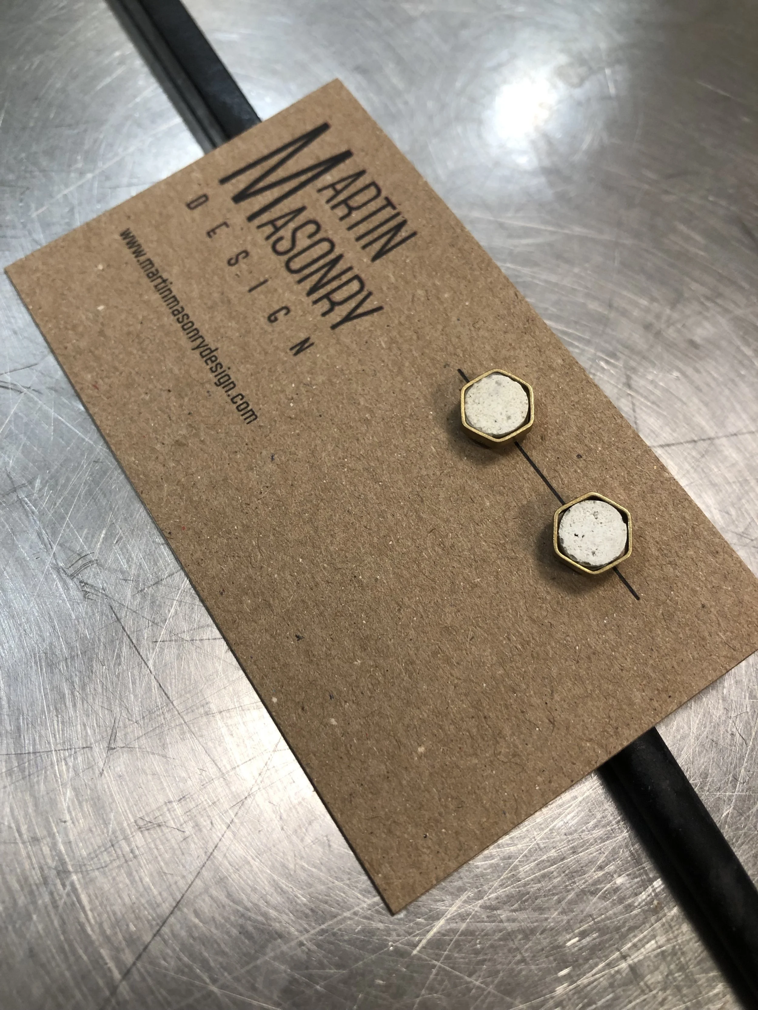 Irregular grout posts with brass hexagons