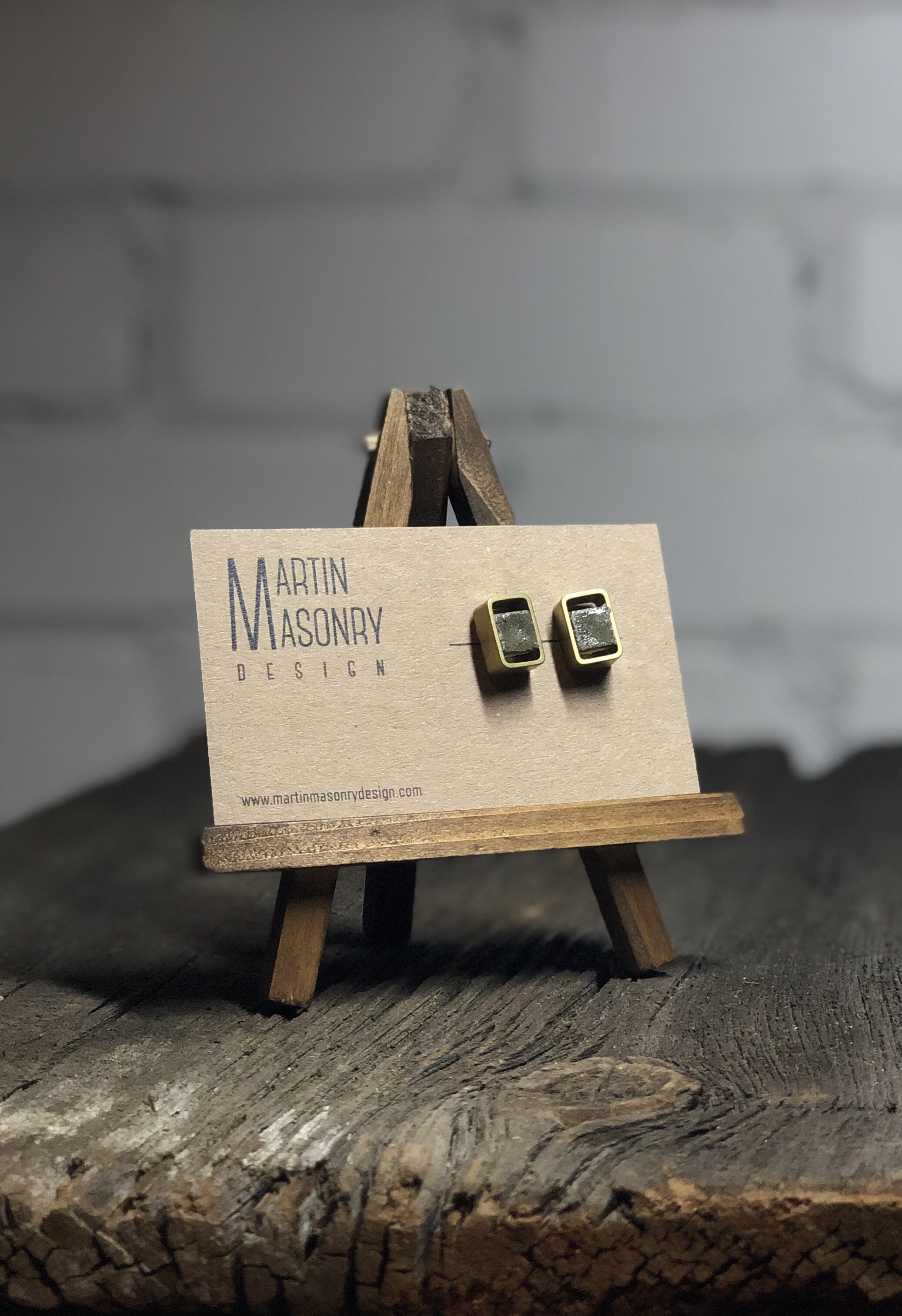 Charcoal grey grout cubes in brass rectangles