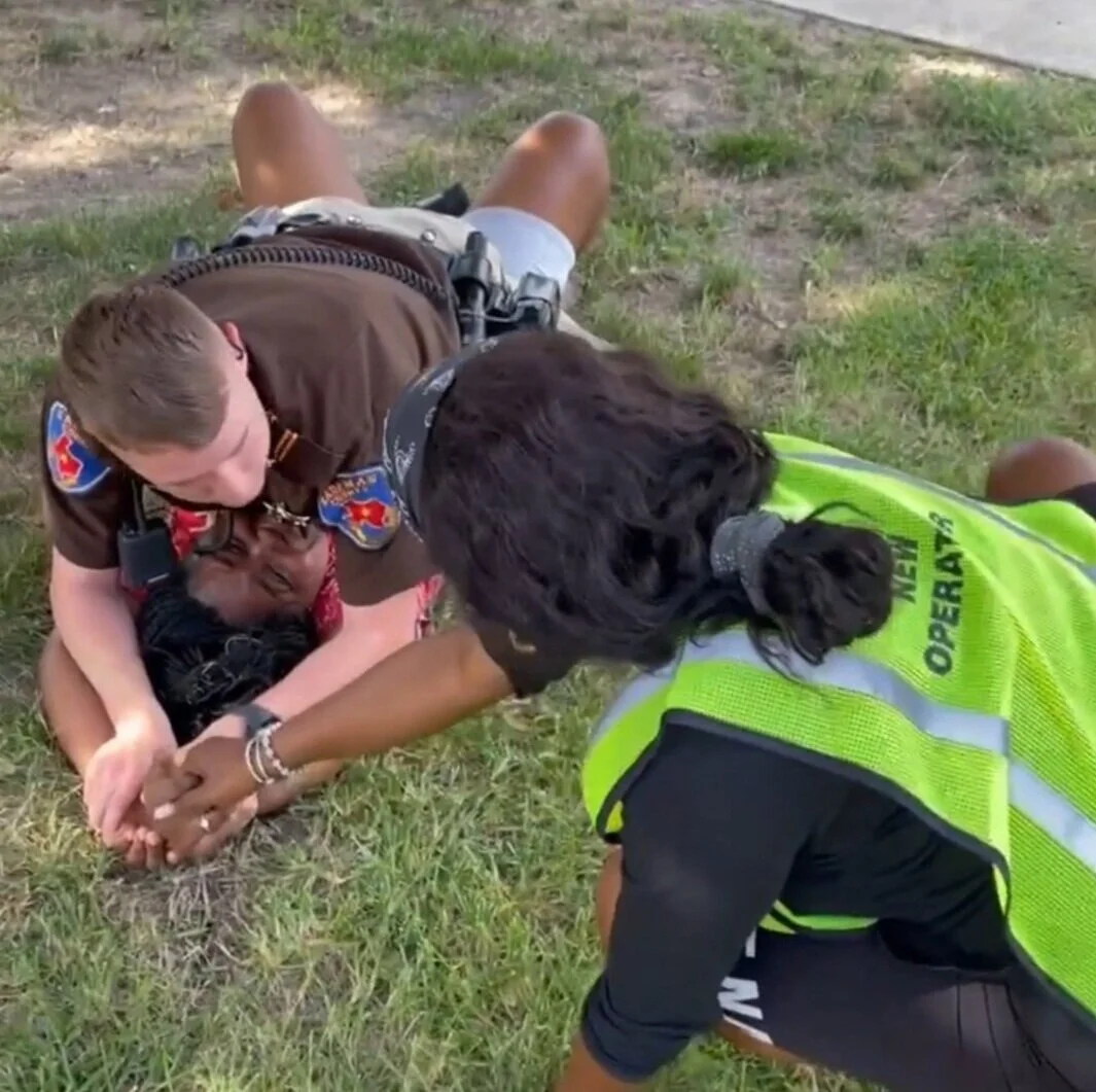 Cell phone footage captures Antanique Ray holding her daughter’s hand while Kaufman County Police rests his body weight on top of her.