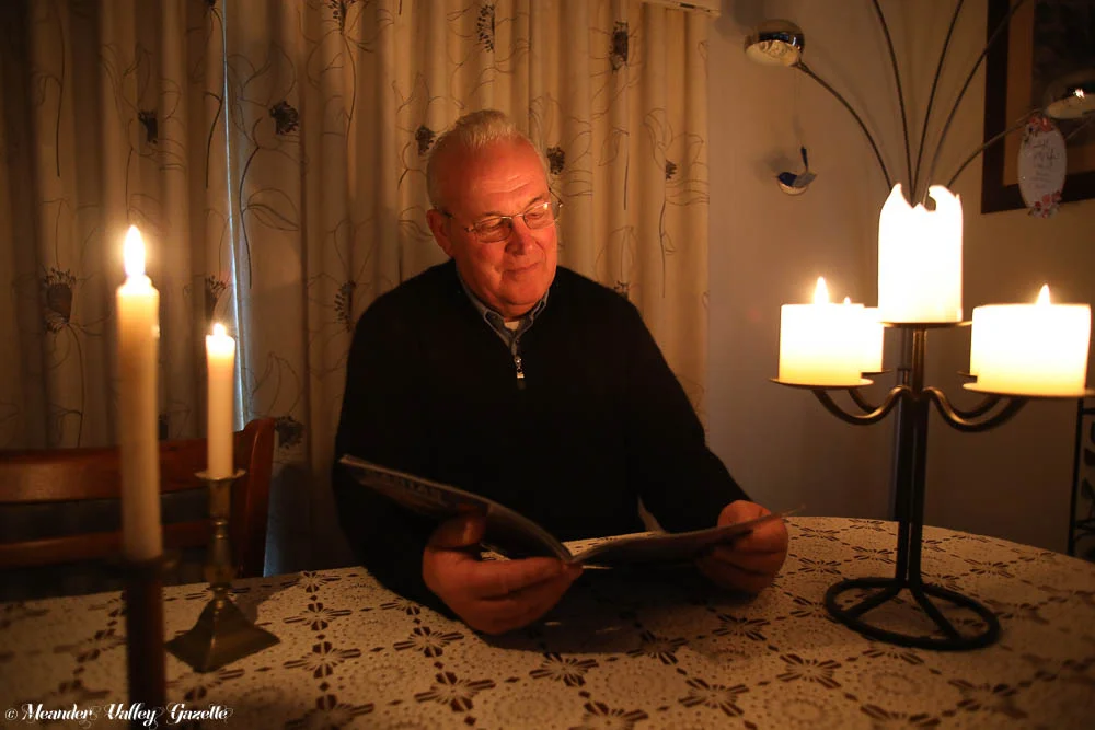 Albert-DeVeth-is-getting-used-to-reading-by-candlelight-during-the-many-power-outages-being-experienced-in-Westbury.jpg
