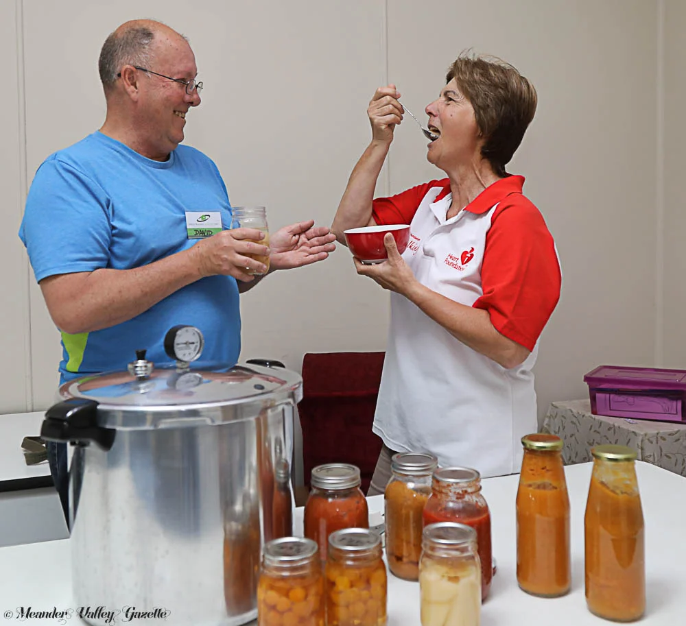 David Hudson from Harvest Helpers tests the newly-preserved produce with Elena Olah from Deloraine House. Photo by Mike Moores