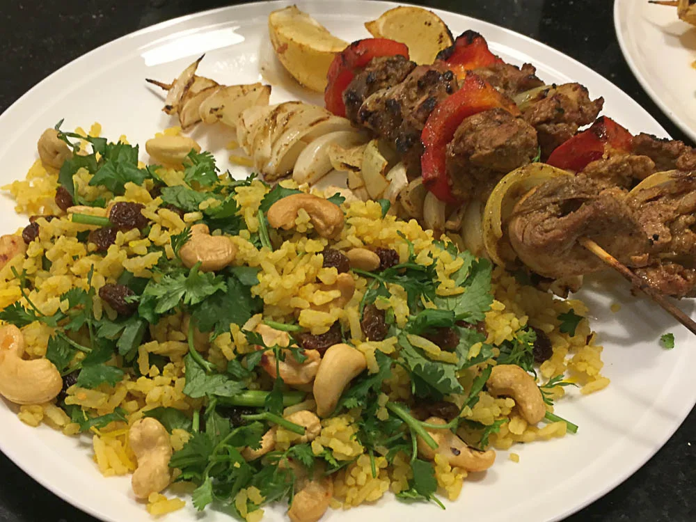 The bright colours of this indian style rice salad work well with the skewers of charry spiced chicken. Photo | Mike Moores