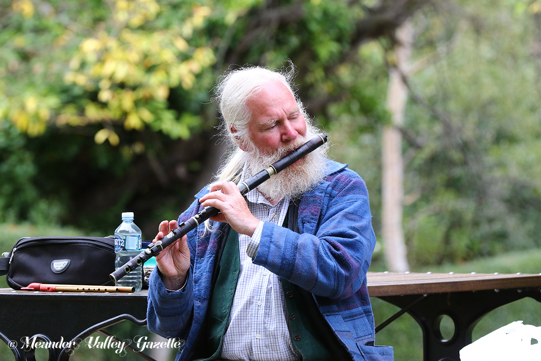 Brian Owens of Ouse, flute and tin whistle player, playing his Indian rosewood flute on the Westbury Village Green. Just one of Brian’s collection of wind instruments, the flute was made in 1837 by an instrument maker called Joseph Wallis, in the Euston Road, London. Photo | Mike Moores