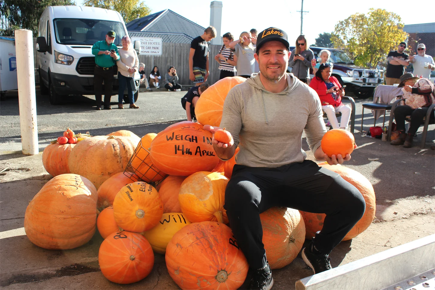 Winning pumpkin grower Andrew Gleeson enthroned on a heap of giant pumpkins. Photo by Hayley Manning