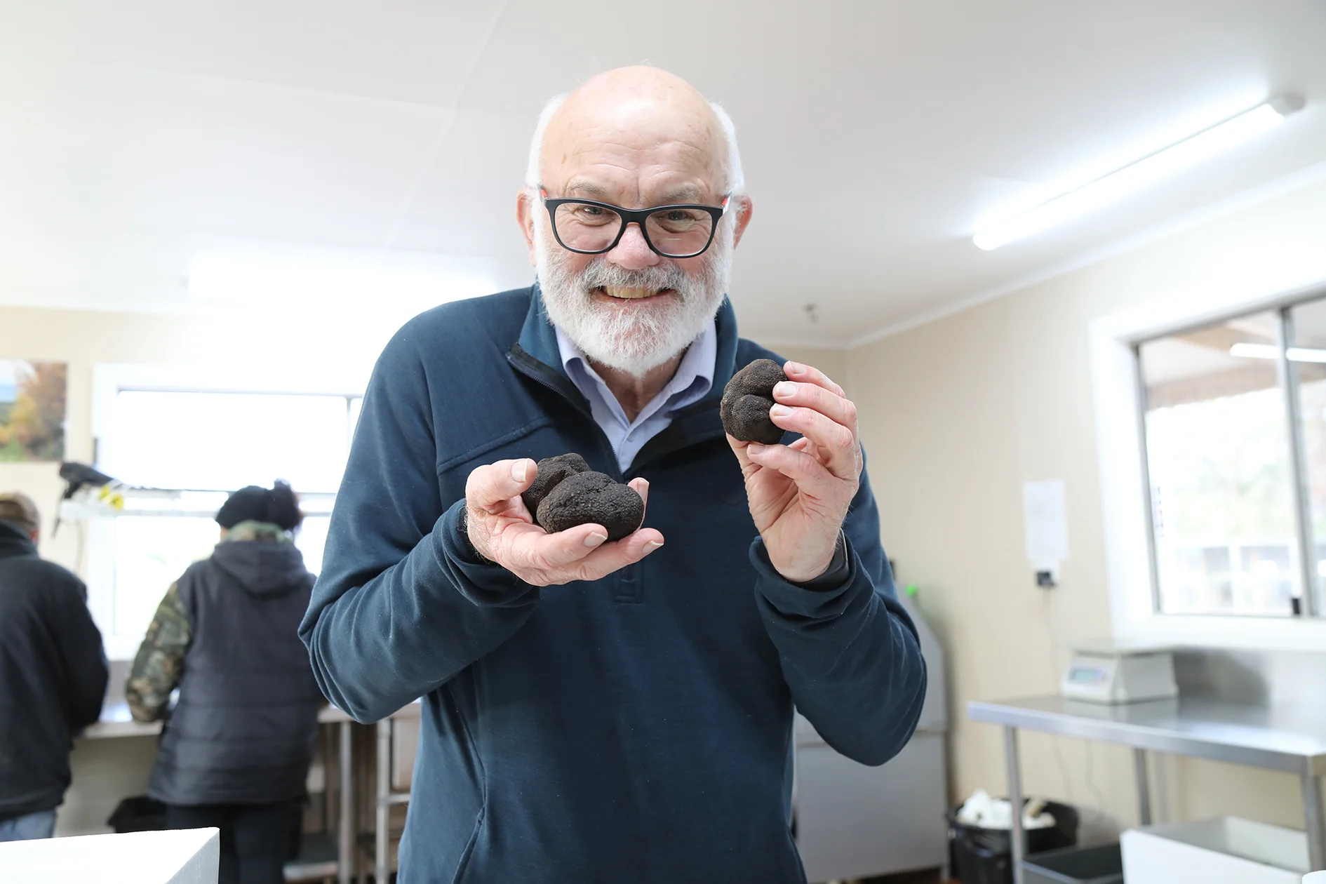 Len Mackenzie and his ‘black gold’ – truffles harvested at Needles in the Meander Valley. Photo by Mike Moores