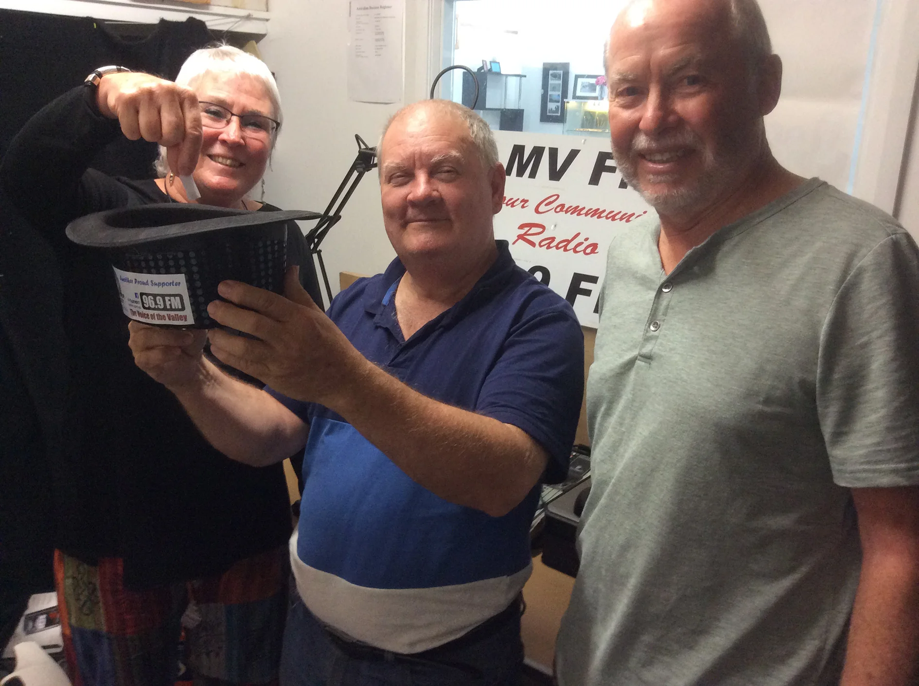From left, Secretary Rijke McGough, Studio Manager / Vice President John Kenzie and Treasurer Tim Biggs picking a lucky winner out of the hat in the fortnightly Members’ draw at the radio station. Photo supplied